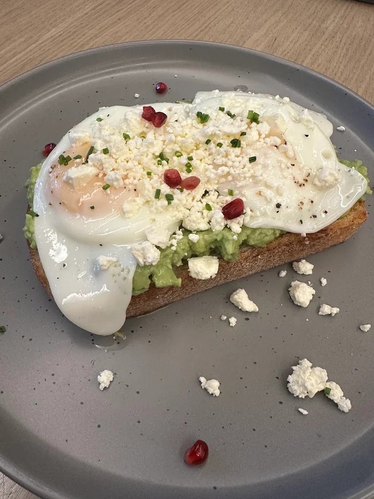 Sourdough with smashed avocado, fried eggs, feta and pomegranate