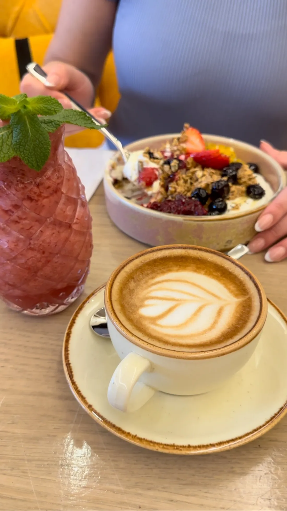 Granola bowl, latte and a fresh juice