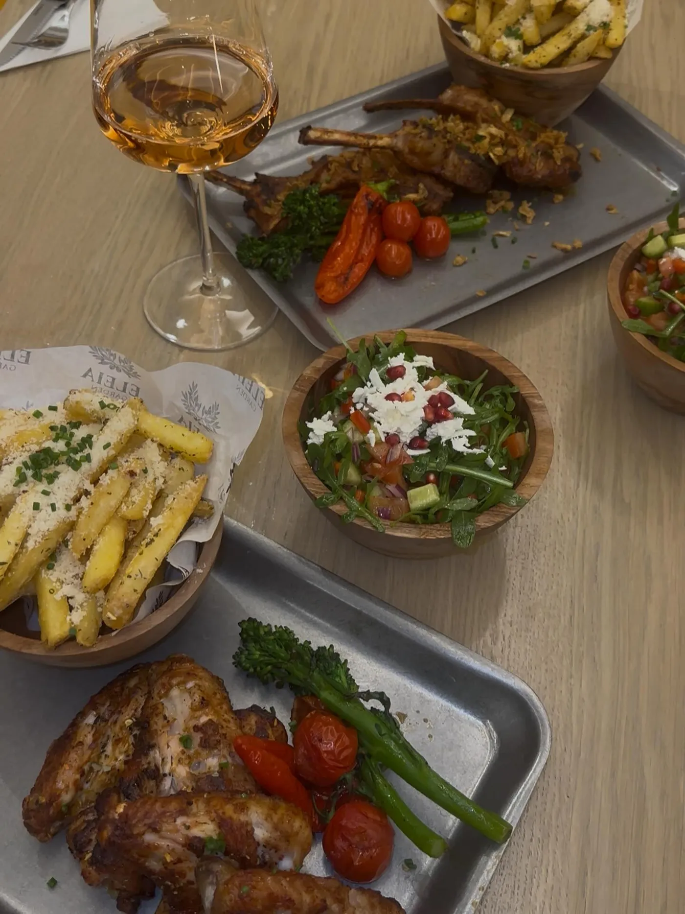 Lamb chops and grilled chicken with chips, salads and a glass of rosé